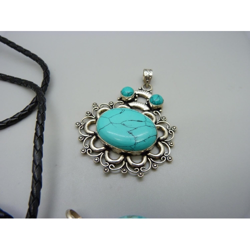 1102 - A silver and turquoise bolo tie, a native American silver bear pendant and one other silver mounted ... 