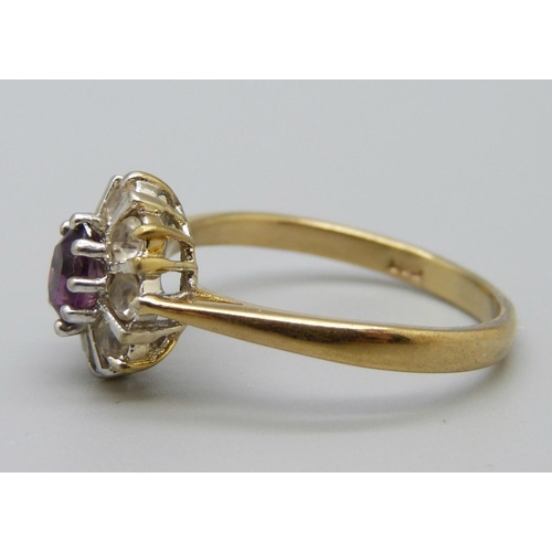 1104 - An amethyst and white stone cluster ring, T