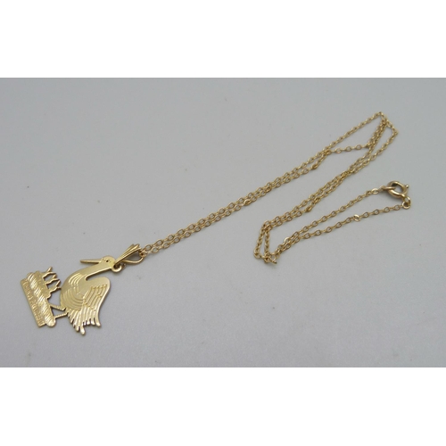 1123 - A 9ct gold 'stork' pendant on a yellow metal chain, total weight 3.7g