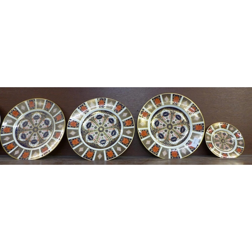 602 - Six Royal Crown Derby dinner plates, 1128 Imari pattern and one side plate, one dinner plate second ... 