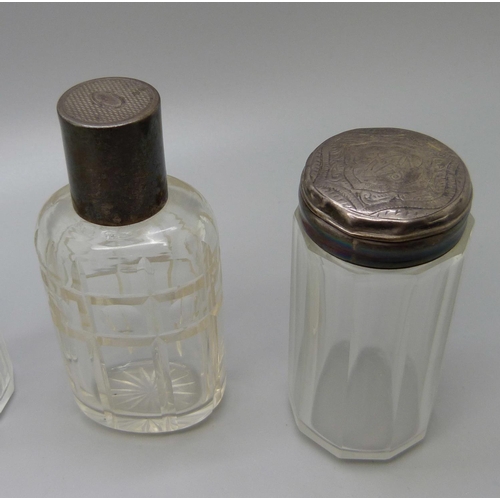 867 - A collection of seven silver topped bottles, scent and salts jar, including Victorian