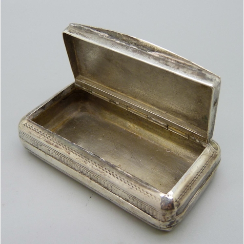 893 - A white metal snuff box, the top decorated with a bird, with diamond shaped control mark