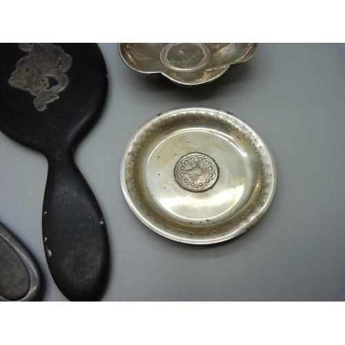 897 - Two white metal dishes inset with coins and two hand mirrors, one silver and tortoiseshell and one w... 