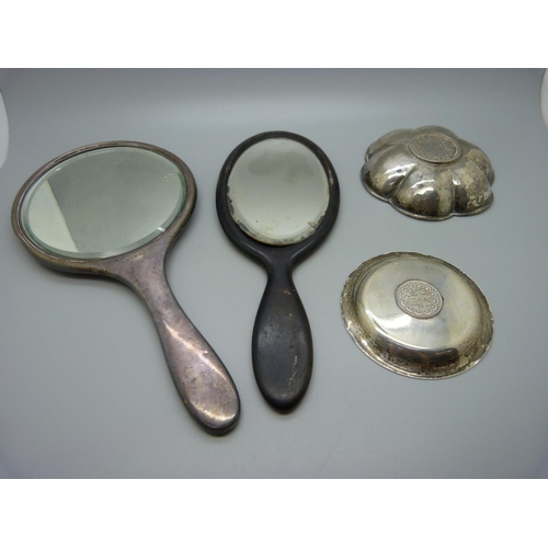 897 - Two white metal dishes inset with coins and two hand mirrors, one silver and tortoiseshell and one w... 