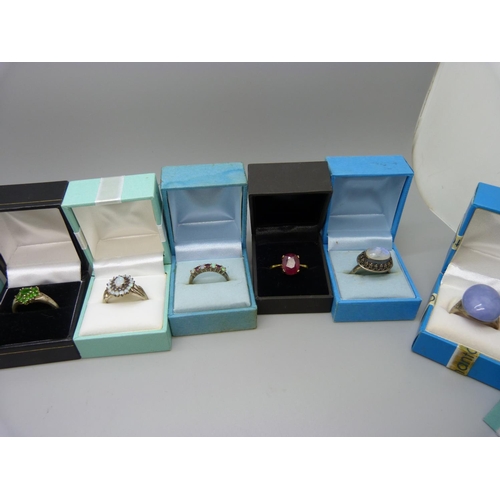 910 - A collection of stone set silver rings including opal