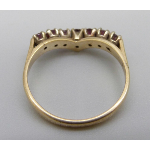 935 - A 9ct gold, seven red stone ring, 2.2g, O