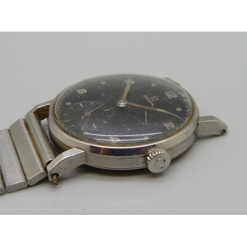 971 - A 1950's Omega wristwatch with black dial and sub dial second hand, manual wind, 31mm case