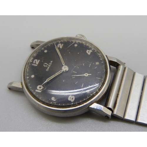 971 - A 1950's Omega wristwatch with black dial and sub dial second hand, manual wind, 31mm case