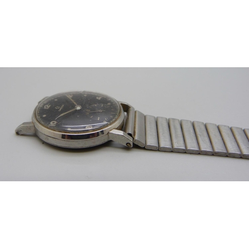 971 - A 1950's Omega wristwatch with black dial and sub dial second hand, manual wind, 31mm case