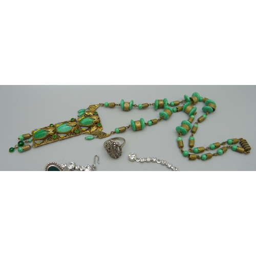 981 - An Egyptian revival necklace, a diamante necklace, two rings and a brooch