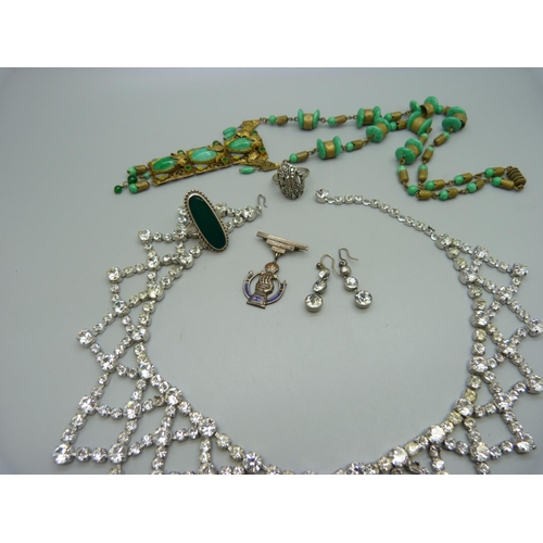 981 - An Egyptian revival necklace, a diamante necklace, two rings and a brooch