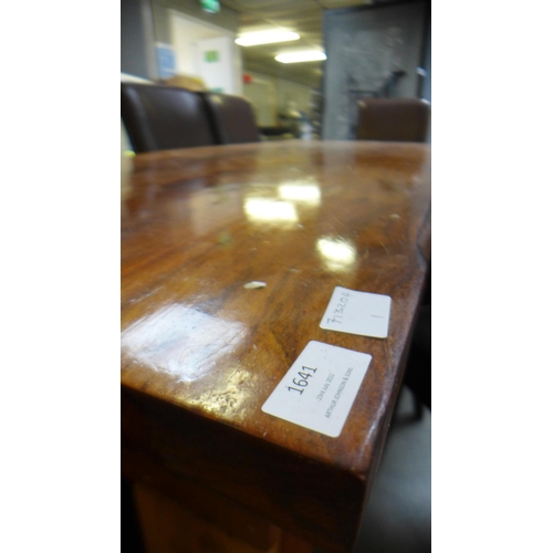 1641 - A large Indian hardwood dining table and eight brown leather and black piping dining chairs