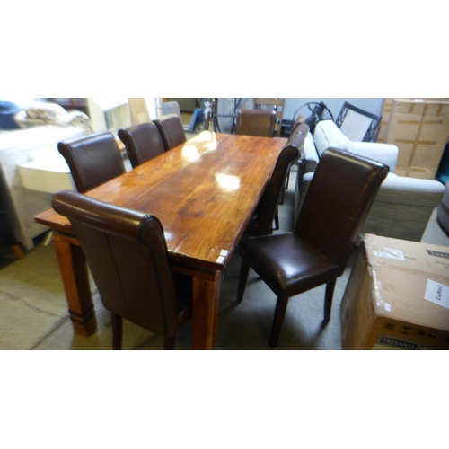 1641 - A large Indian hardwood dining table and eight brown leather and black piping dining chairs