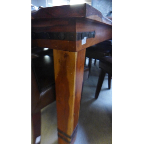 1641 - A large Indian hardwood dining table and eight brown leather and black piping dining chairs