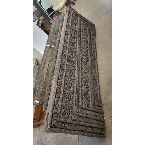 230 - Five Indian carved hardwood panels, including a pair of doors, 181 x 59cms, a pair of panels, 181 x ... 