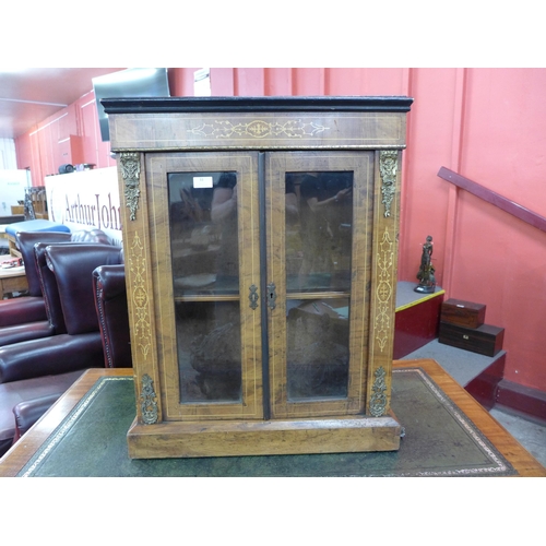 599 - A small Victorian inlaid walnut and ormolu mounted pier cabinet