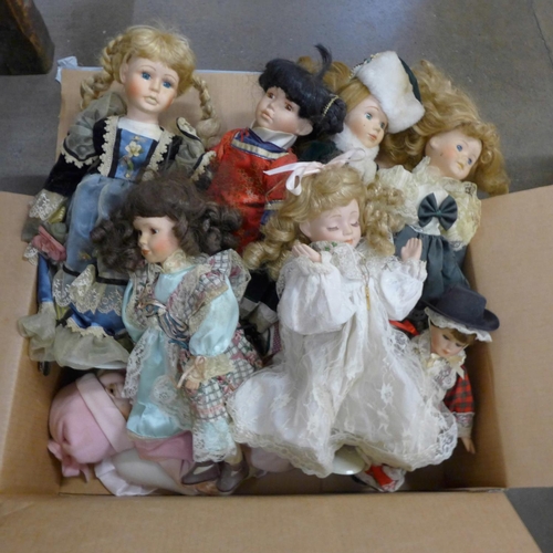 1100 - A box of porcelain dolls **PLEASE NOTE THIS LOT IS NOT ELIGIBLE FOR POSTING AND PACKING**