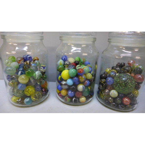 669 - Four jars of vintage marbles including clay