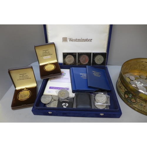 715 - A tin of British and foreign coins and a case of commemorative crowns