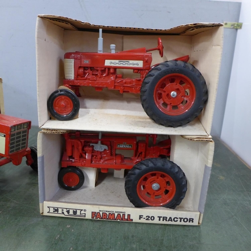 796 - An Ertl Farmall 350 tractor and F-20 tractor, boxed and two other Ertl tractors, play worn