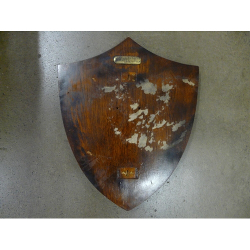 817 - A shield with military related badges, etc.