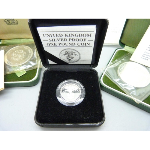 876 - A Maria Theresia silver Thaler, cased, two silver proof crowns and a silver one pound coin, all boxe... 