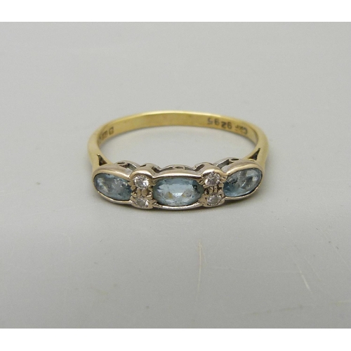 950 - An 18ct gold, diamond and blue stone ring, 2.3g, O