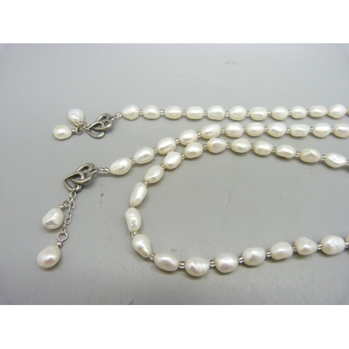 954 - A pearl necklace and two bracelets