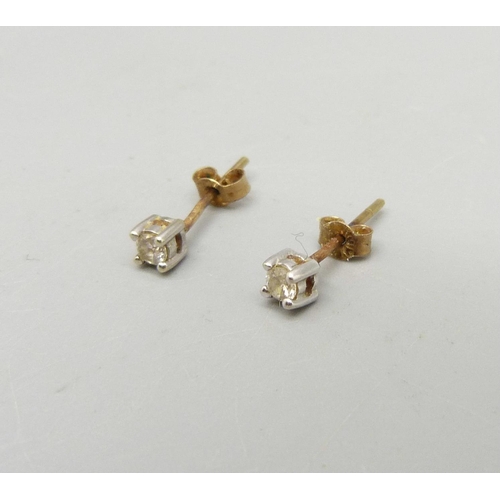 977 - A pair of 9ct gold and diamond ear studs