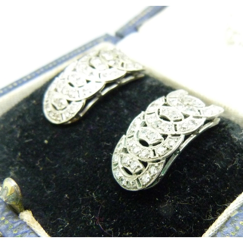 980 - A pair of Art Deco earrings set with seventy-two diamonds, test as platinum, 10mm wide