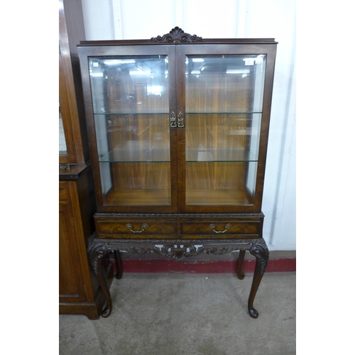 145 - A Queen Anne style figured walnut display cabinet on stand