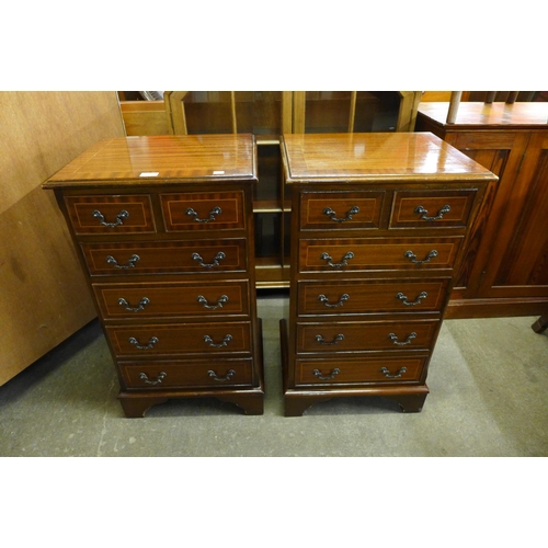 152 - A pair of inlaid mahogany chests of drawers