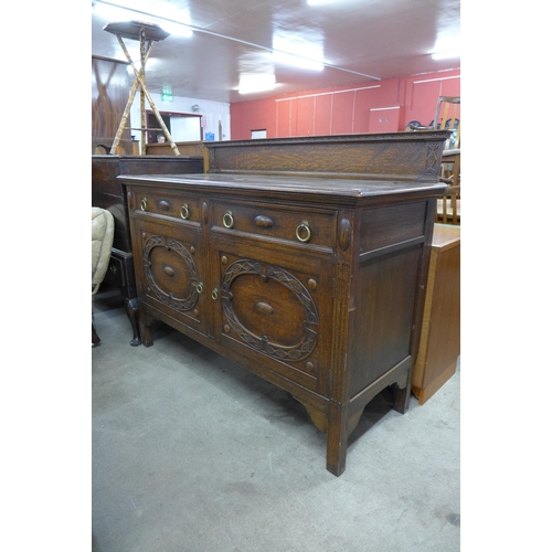 176 - An early 20th century carved oak sideboard