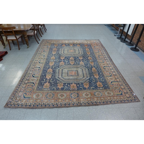 187 - An eastern salmon pink and blue ground hand knotted rug, 337 x 275cms