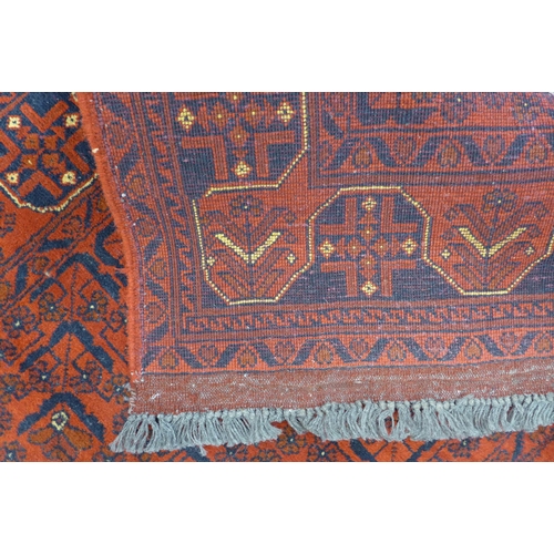 188 - A Turkish hand knotted red ground runner, 582 x 80cms