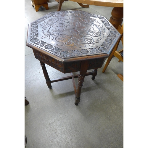 216 - A carved mahogany octagonal centre table