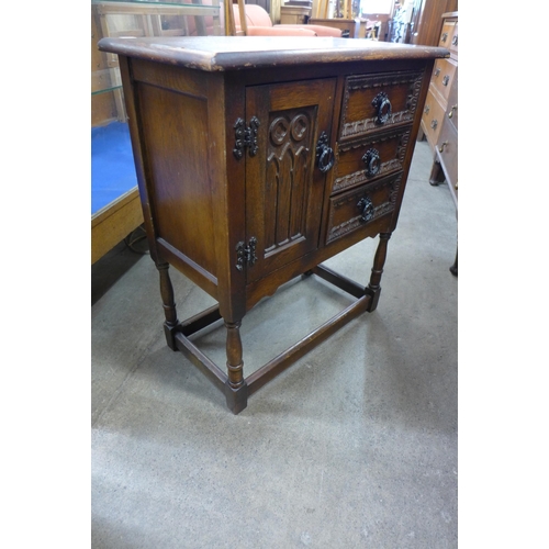 219 - A small Old Charm carved oak cupboard