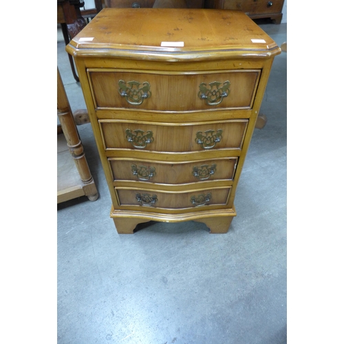 220 - A small yew wood serpentine chest of drawers