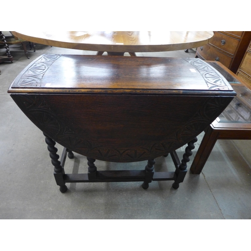 224 - A carved oak barleytwist gateleg table