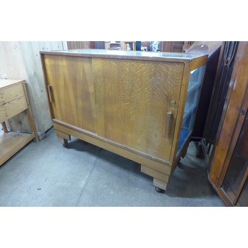 226 - An Art Deco glazed oak shop cabinet