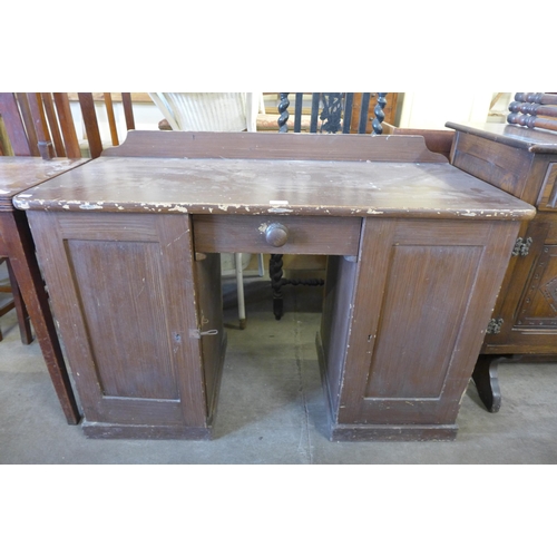 256 - A Victorian stained pine kneehole desk