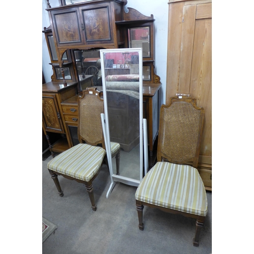 294 - A pair of elm effect bergere side chairs and a cheval mirror