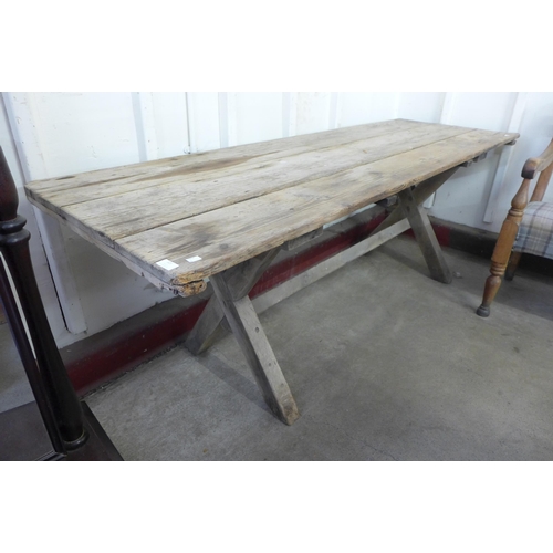 321 - A Gothic pine x-frame farmhouse refectory table