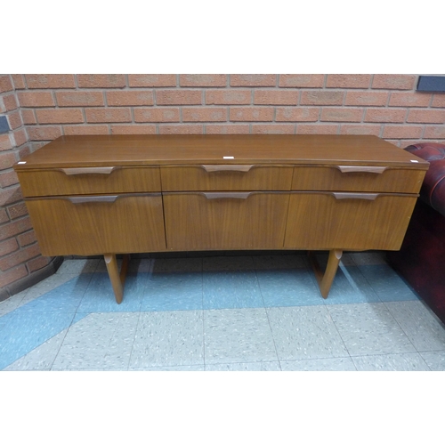 38 - A teak concave sideboard