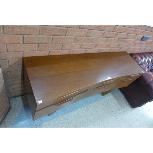 38 - A teak concave sideboard