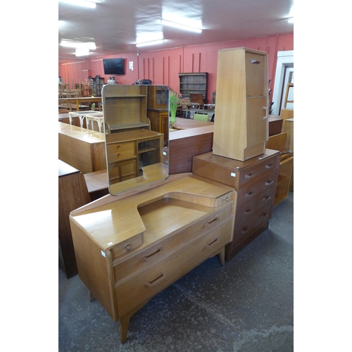 52 - A G-Plan Brandon oak three piece bedroom suite, comprising chest of drawers, dressing table and a po... 