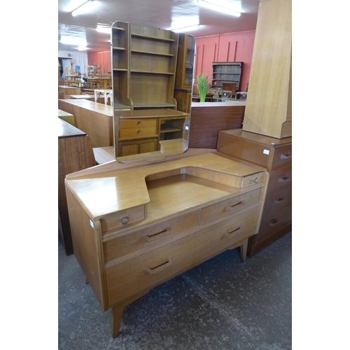 52 - A G-Plan Brandon oak three piece bedroom suite, comprising chest of drawers, dressing table and a po... 