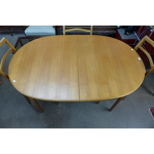 77 - A McIntosh teak extending dining table and six chairs