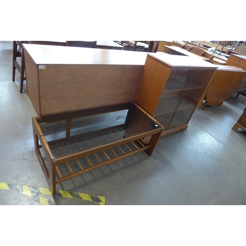 87 - A teak and smoked glass topped coffee table and a small teak bookcase