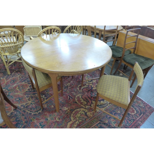 91 - A McIntosh teak extending dining table and four chairs